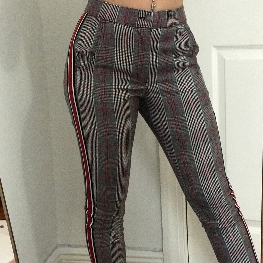 A pair of black, red, and white plaid Hollister pants